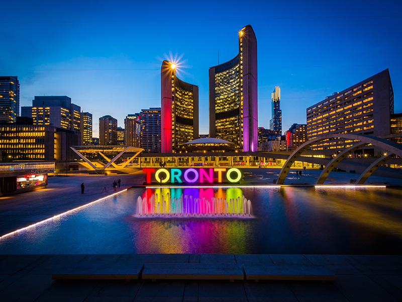 View of Nathan Phillips Square and Toronto Sign in downtown at night, in Toronto, Ontario.