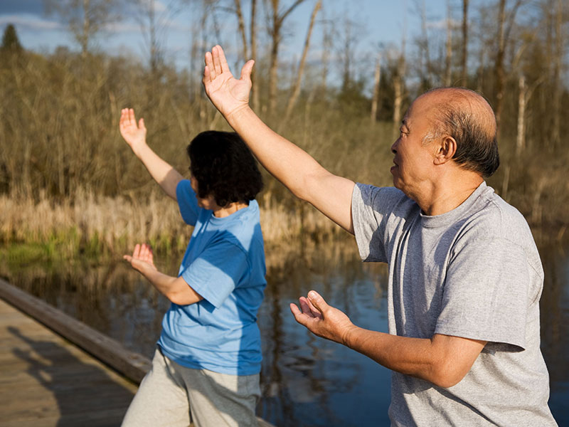 A shot of a senior asian couple doing tai-chi exercise