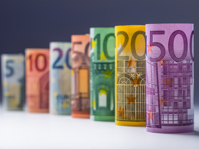 Several hundred euro banknotes stacked by value. Euro money concept. Rolls Euro banknotes. Euro currency. Announced cancellation of five hundred euro banknotes. Banknotes stacked on each other in different positions. Toned photo.