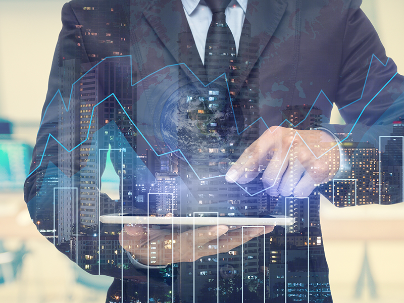 Double exposure of businessman using the tablet with cityscape and financial graph which have earth and world map on computer blurred background