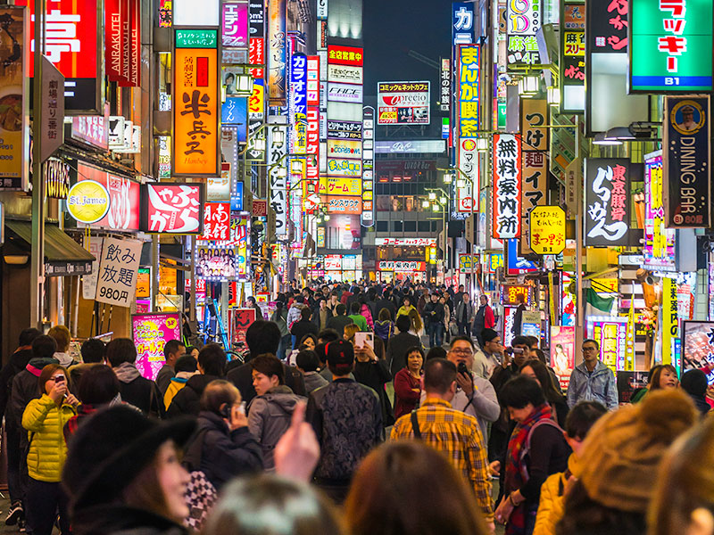 Tokyo nightlife crowded streets and colourful neon shopping signs Japan