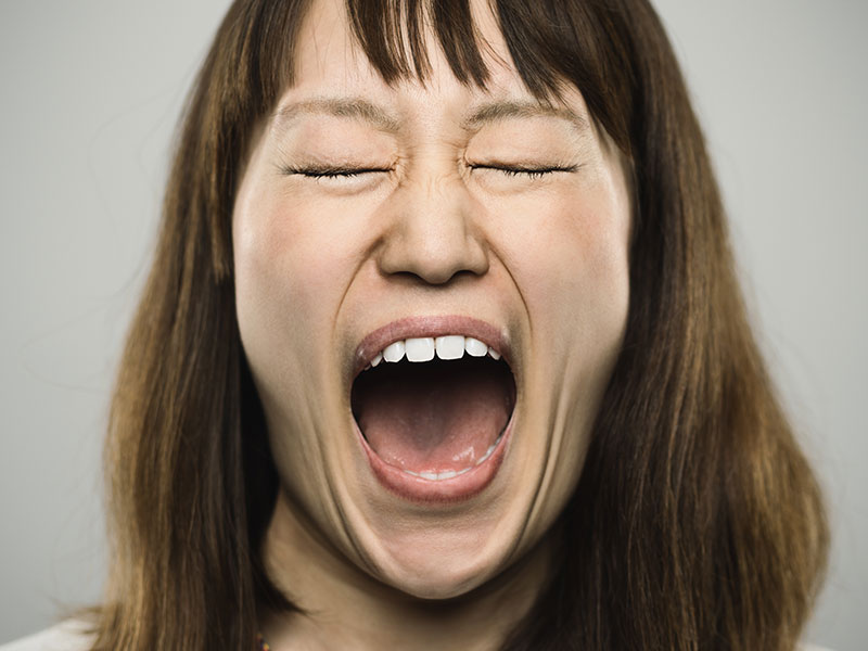 Portrait of a young japanese woman screaming