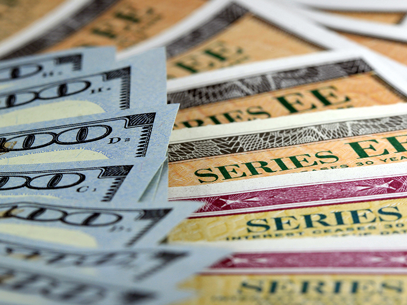 United States treasury savings bonds with one hundred dollar bills