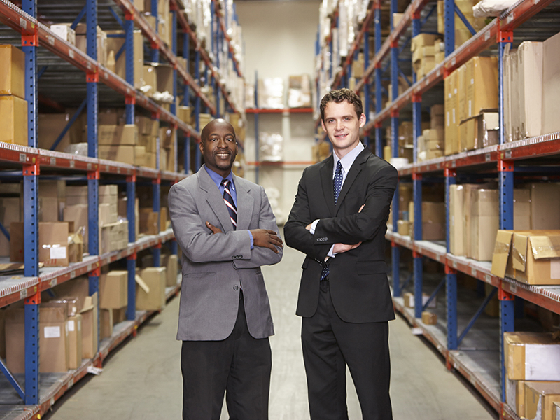 portrait of two businessmen in warehouse