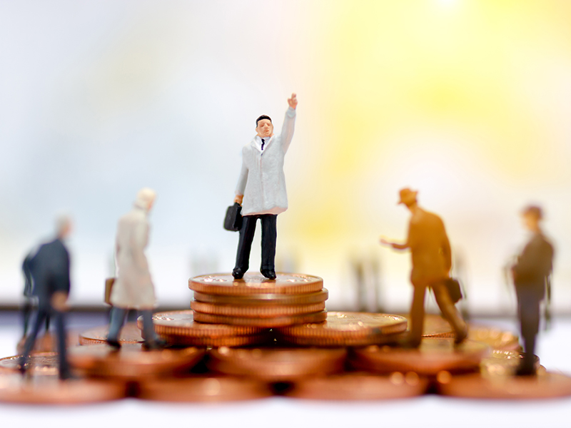 Miniature business people standing on step of coin money. Finance, investment and growth in business concept.
