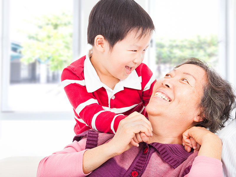 Stock Photo - a boy playing with grandmother at home