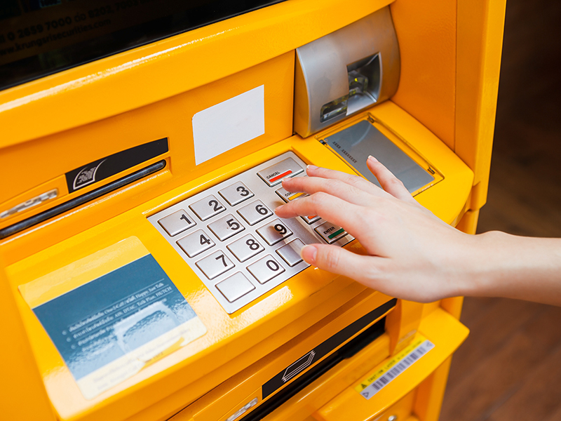 Finger pressing password number on ATM machine