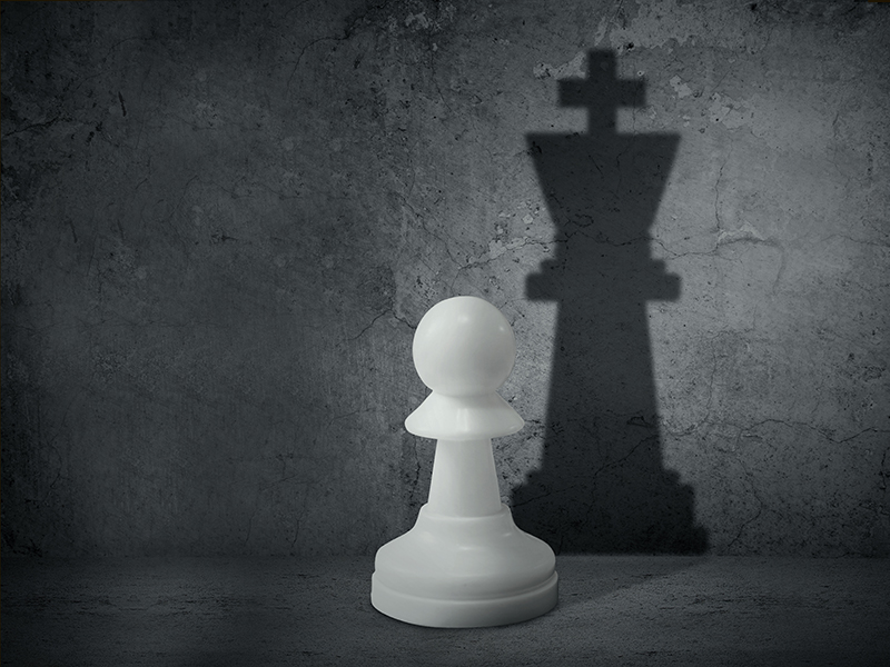 White chess pawn with the shadow of a king