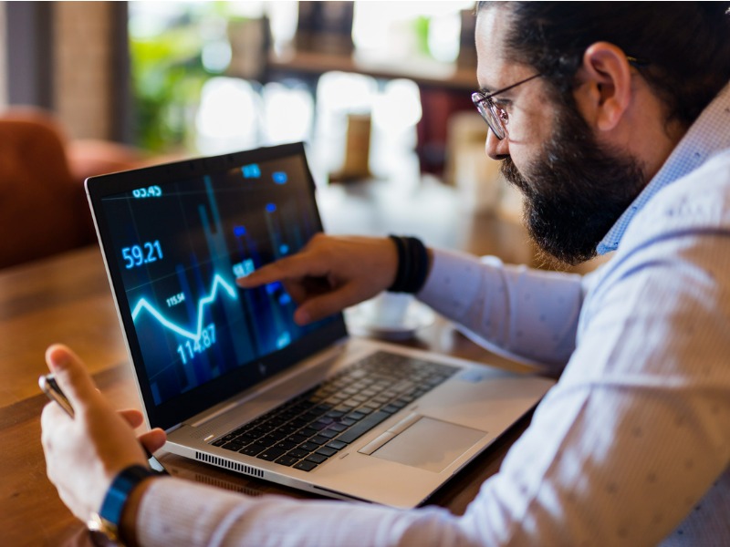 Businessman using laptop for analyzing data stock market stock photo