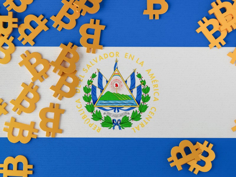 El Salvador flag with Bitcoin icons above stock photo