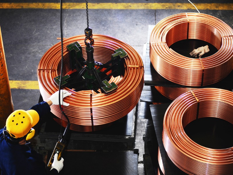 Overview of worker testing copper coils stock photo