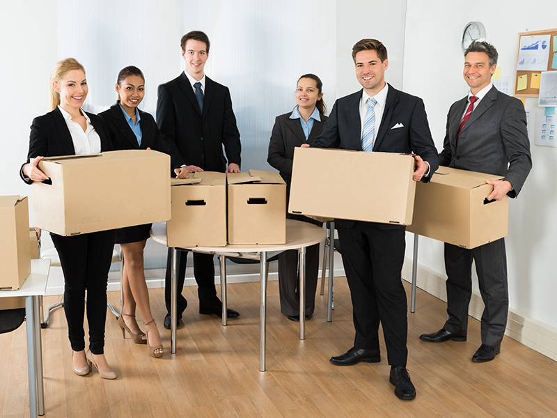 Portrait Of Happy Multiethnic Employees In Office Holding Cardboard Boxes
