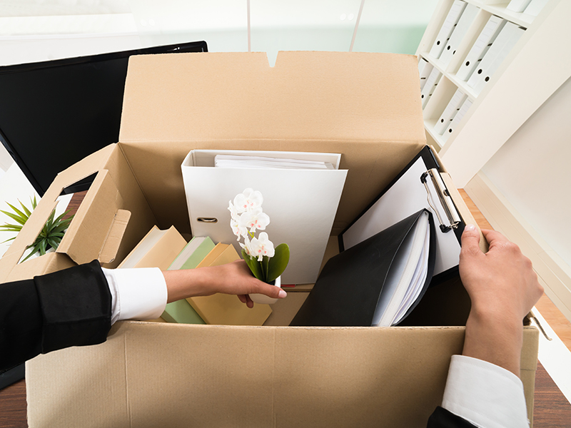 High Angle View Of Businesswoman Packing Personal Belonging In Box