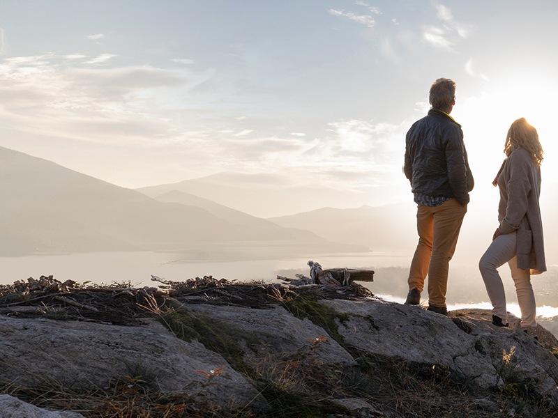 Couple standing proudly on mountain top