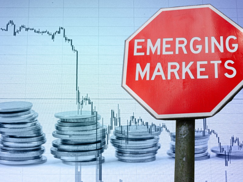 Emerging markets sign against economy background with graph and coins stock photo