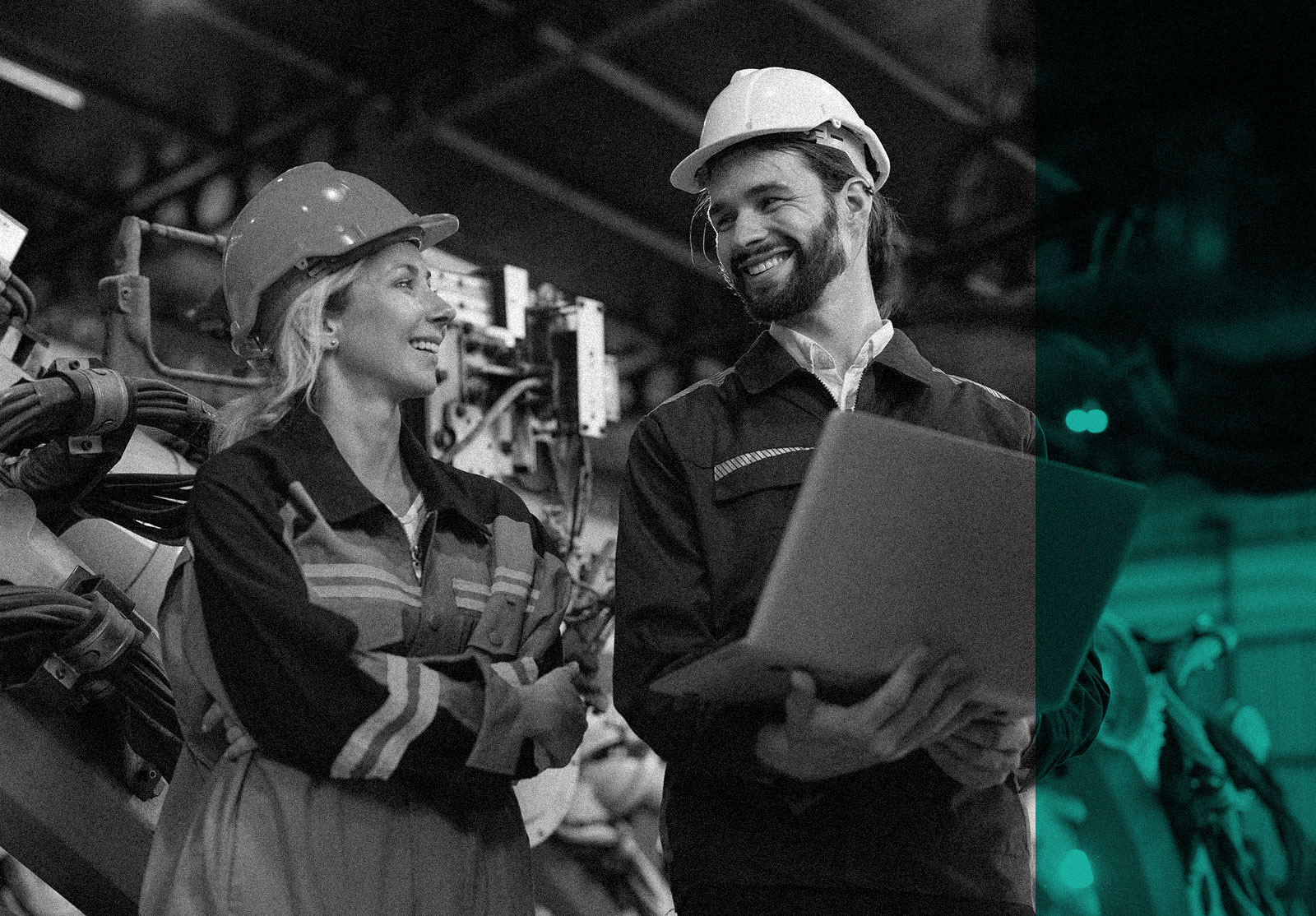 Man and woman smiling on factory floor