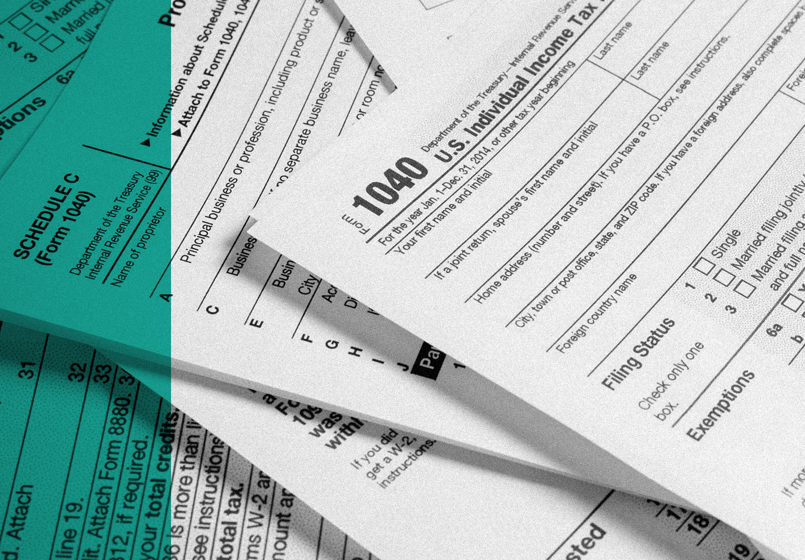 A variety of United States tax forms with a pencil