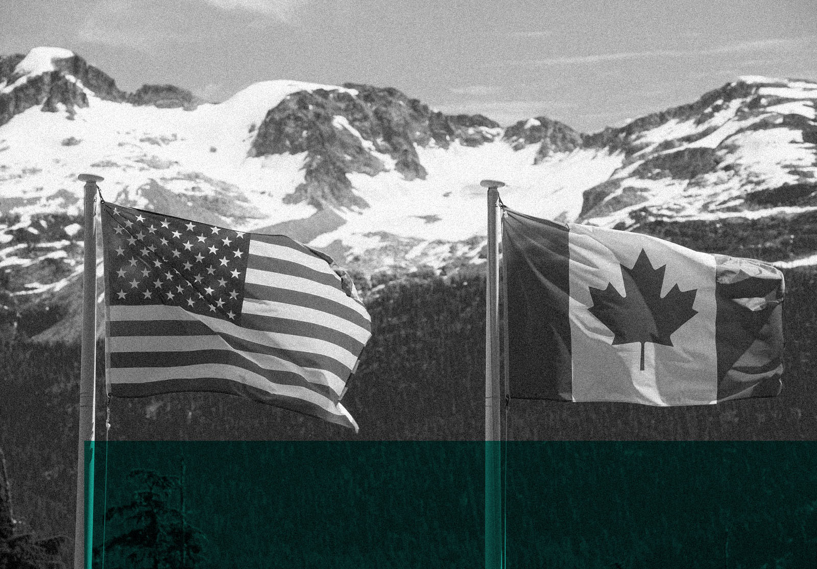 Canadian and American flags in the mountains